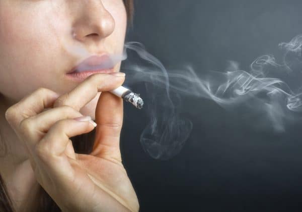 Woman with Cigarette Exhaling Smoke